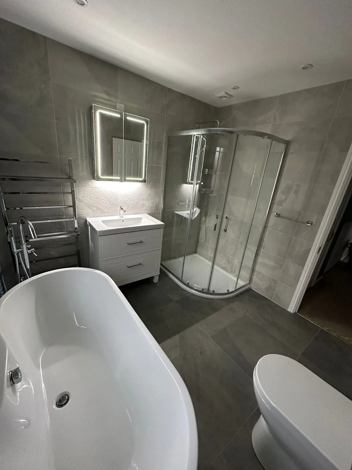 a white bath tub sitting next to a white toilet